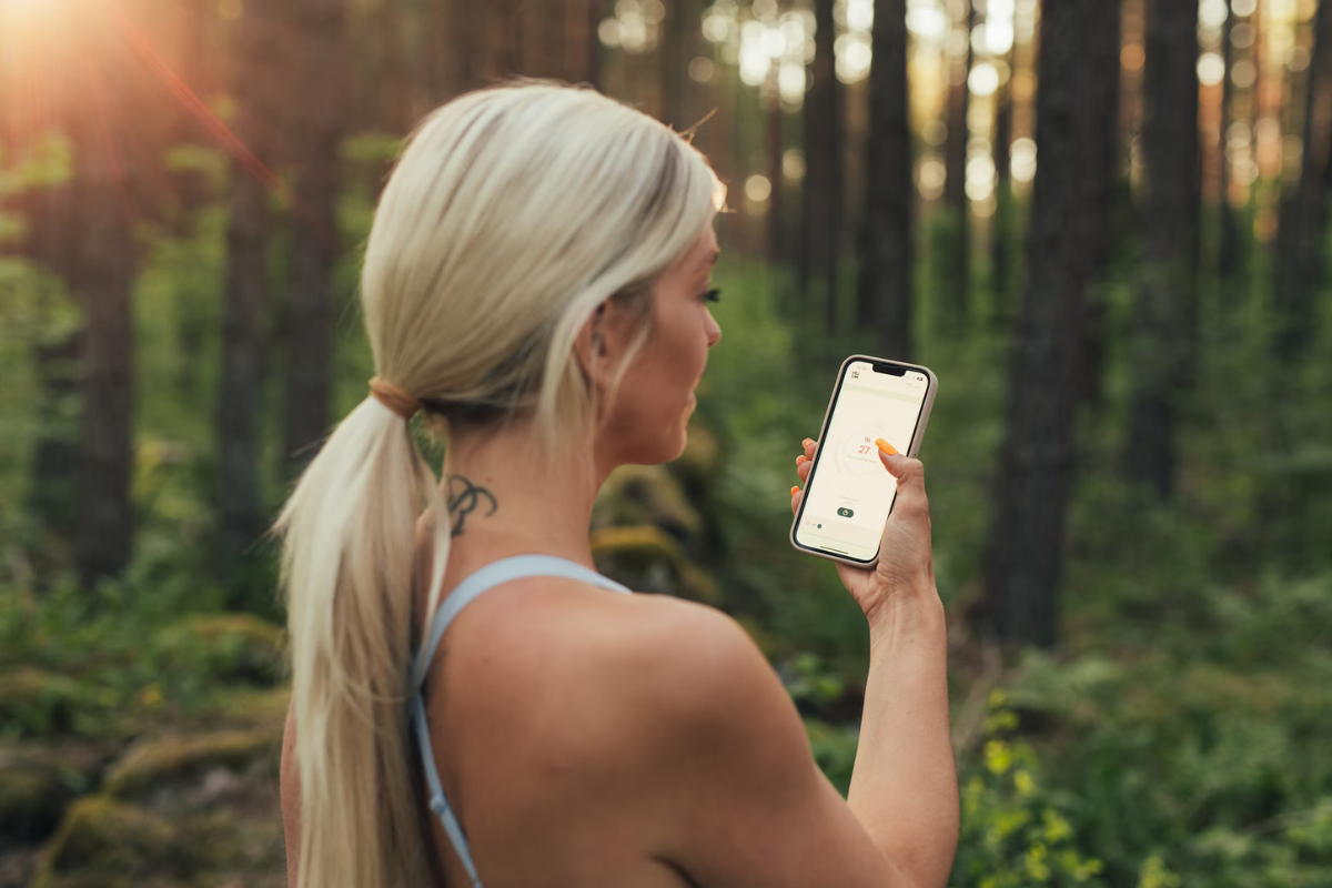 "Woman tracking menopause symptoms with app 2025"
